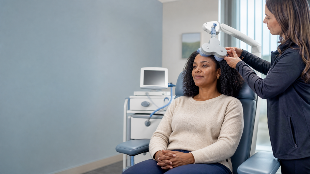 How does TMS work: awake patient receiving targeted magnetic brain stimulation from a coil positioned against the scalp.